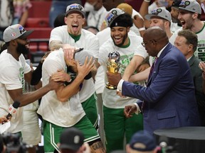 Boston Celtics forward Jayson Tatum (0) and teammates react after Tatum won the Larry Bird Eastern Conference Finals MVP trophy after game seven of the 2022 eastern conference finals at FTX Arena.