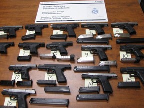 A cache of 15 handguns and 26 magazines seized by CBSA from a vehicle that tried to enter Canada via the Ambassador Bridge on June 20, 2019.