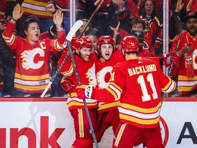 Calgary Flames left wing Andrew Mangiapane (88) celebrates his goal with teammates against the Dallas Stars during the third period in game five of the first round of the 2022 Stanley Cup Playoffs at Scotiabank Saddledome.