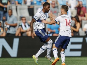 Vancouver Whitecaps striker Tosaint Ricketts, left, celebrates with teammate Sebastian Berhalter after scoring against Charlotte FC in the second minute of the first half of an MLS soccer match in Charlotte, N.C., Sunday, May 22, 2022.