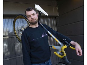 Ben Bolliger holds his broken bicycle in March after getting a bill for more than $3,000 for a crash in which he was seriously injured.