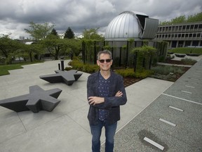 Howard Trottier is a professor of particle physics at Simon Fraser University, where he is pictured at the Trottier Observatory and Science Courtyard.