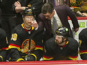 Vancouver Canucks associate coach Brad Shaw points in front of Alex Chiasson (left) and Conor Garland (bottom right) versus Seattle Kraken during NHL hockey at Rogers Arena in Vancouver, BC., April 26, 2022.