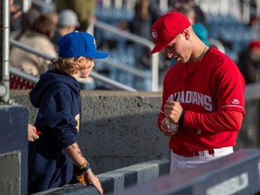 Vancouver Canadians infielder/outfielder Trevor Schwecke signs an autograph for a young fan. He was a 13th round draft pick in 2019 of the Toronto Blue Jays and he's been one of the C's best hitters in the early part of this season.