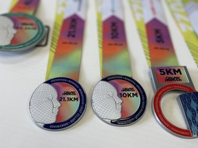 Photos of participant medals for the Calgary Marathon, which is happening on Sunday. The medals are stuck at sea due to backlogs at the Port of Vancouver.