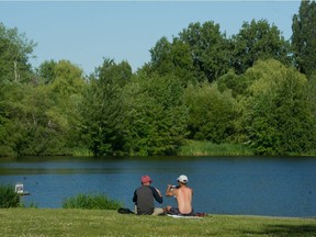 People enjoy the weather at Trout Lake in Vancouver, BC, June 16, 2021.