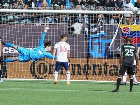 Vancouver Whitecaps goalie Max Anchor (50) dives for a wide shot by Charlotte FC during the first half at Bank of America Stadium.