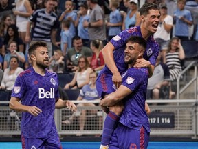 May 28, 2022;  Kansas City, Kansas, United States;  Vancouver Whitecaps forward Lucas Cavallini (9) celebrates with teammates against Sporting Kansas City after scoring in the first half at Children's Mercy Park.