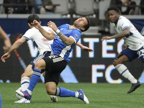 Vancouver Whitecaps forward Russell Teibert (31) blocks San Jose Earthquakes midfielder Eric Remedi (5) during the first half at BC Place.