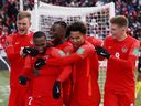 Canada's junior Hoilett celebrates scoring with his teammates during a World Cup qualifier at BMO Field in Toronto on March 27, 2022.
