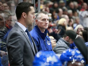 Vancouver Canucks athletic therapist Jon Sanderson (in blue jacket) on the bench at Rogers Arena. Sanderson, who dismissed by the Canucks on Friday, celebrated his 1500th game in the NHL on Dec. 19, 2019.