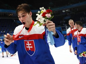 Juraj Slafkovsky #20 of Team Slovakia holds up the Bronze Medal after the Men's Ice Hockey Bronze Medal match between Team Sweden and Team Slovakia on Day 15 of the Beijing 2022 Winter Olympic Games at National Indoor Stadium on February 19, 2022 in Beijing, China.