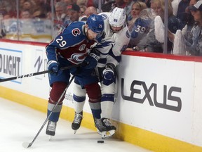 Nikita Kucherov #86 of the Tampa Bay Lightning is checked by Nathan MacKinnon #29 of the Colorado Avalanche during the first period in Game Two of the 2022 NHL Stanley Cup Final at Ball Arena on June 18, 2022 in Denver, Colorado.