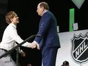 Filip Johansson (left) is greeted by NHL Commissioner Gary Bettman after being selected by the Minnesota Wild in the NHL Hockey Draft in Dallas, Friday, June 22, 2018.