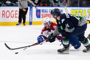 Edmonton Oil Kings’ Josh William (left) dives past Seattle Thunderbirds’ Kevin Korchinski (right) during second period WHL Championships action at Rogers Place in Edmonton, on Friday, June 3, 2022.