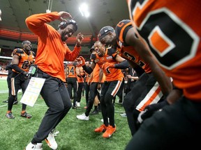 Defensive coordinator Ryan Phillips (left) leads the sideline dance for his Lions defensive unit during their season-opening win against the Edmonton Elks at B.C. Place Stadium.