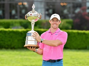 Rory McIlroy of Northern Ireland poses with the trophy after winning the RBC Canadian Open at St. George's Golf and Country Club.