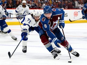 Cale Makar of the Colorado Avalanche carries the puck in front of Anthony Cirelli of the Tampa Bay Lightning during Game 1 of the 2022 Stanley Cup final at Ball Arena in Denver on June 15, 2022.