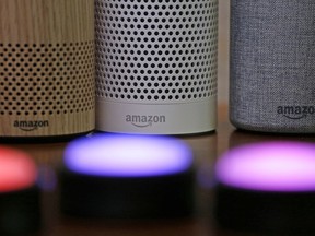 Amazon Echo and Echo Plus devices, behind, sit near illuminated Echo Button devices during an event by the company in Seattle on Sept. 27, 2017.
