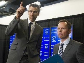 Chris Brumwell (right, with Trevor Linden in this photo from 2014) has been let go by the Vancouver Canucks.