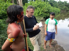 Veteran foreign correspondent Dom Phillips (centre) talks to two indigenous men in Brazil, on November 16, 2019.
