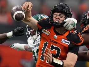 B.C. Lions quarterback Nathan Rourke is sacked by Saskatchewan Roughriders' Garrett Marino, back, and fumbles the ball during the first half of a pre-season CFL football game in Vancouver, B.C., Friday, June 3, 2022.