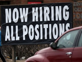 Signs like this one in Winnipeg in April are becoming more common as job vacancies in Canada soar.
