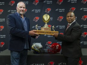 UBC Thunderbirds head coach Blake Nill (left) and SFU head coach Mike Rigell with the Shrum Bowl trophy back in June when it was announced that the infrequently played game was back on again after a 12-season hiatus for this Friday on Burnaby Mountain.