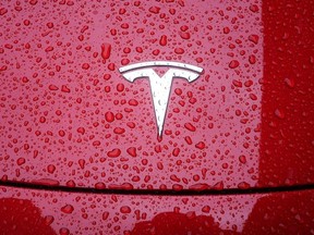 A Tesla logo is pictured on a car in the rain in the Manhattan borough of New York City, New York, U.S., May 5, 2021.