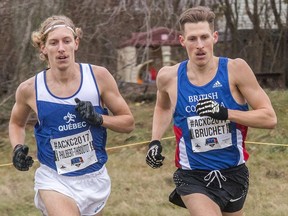 Canadian Olympians Charles Philibert-Thiboutot, left, of Quebec City and Luc Bruchet of Vancouver appear to be running in perfect unison as they head into a corner during the senior men's race at the Athletics Canada Cross-Country Championships on Nov. 25, 2017, at Fort Henry in Kingston, Ont.