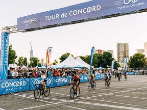 InstaFund Racing’s Rylee McMullen, in blue and white with her arm up, won the women’s cycling race at the 2022 Tour de Concord on Thursday, June 30 in Vancouver, hosted by Cycling B.C. and Concord Pacific.