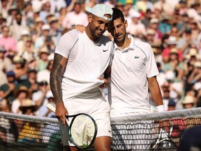 LONDON, ENGLAND - JULY 10: Winner Novak Djokovic of Serbia (L) and runner up Nick Kyrgios of Australia interact by the net following their Men's Singles Final match day fourteen of The Championships Wimbledon 2022 at All England Lawn Tennis and Croquet Club on July 10, 2022 in London, England.