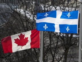 The Canadian and Quebec flag as as seen at city hall in Montreal on Monday November 19, 2018.