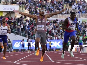Andre De Grasse, of Canada, crosses the finish line first the final of the men's 4x100-metre relay at the World Athletics Championships on Saturday, July 23, 2022, in Eugene, Ore.