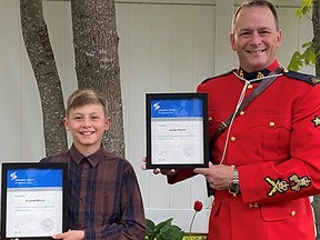 RCMP Cpl. James Moore and his 11-year-old son Emmett are honoured for saving the life of two men in a capsized canoe near Revelstoke. Photo credit: RCMP