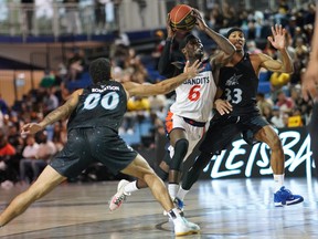 Fraser Valley Bandits guard Alex Campbell drives to the hole against the Scarborough Shooting Stars' Kassius Robertson, left, and Marcus Anderson during Thursday night's game in Scarborough.