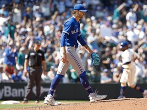 Blue Jays relief pitcher Adam Cimber walks back to the mound after surrendering a two-run home run to Seattle Mariners' Carlos Santana during the eighth inning at T-Mobile Park.