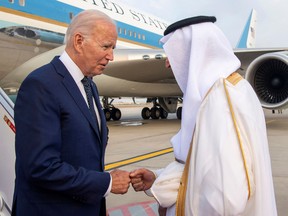 A handout picture released by the Media Office of the Mecca governor on July 15, 2022, shows the governor Prince Khaled al-Faisal (R) welcoming US President Joe Biden upon his arrival in Jeddah.