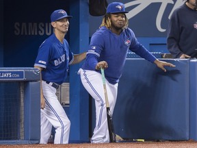Toronto Blue Jays' Vladimir Guerrero Jr., right, pretends to coach with first base coach Mark Budzinski in the sixth inning of their American League MLB baseball game against the Tampa Bay Rays in Toronto on Sept. 28, 2019.