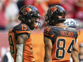 BC Lions' Dominique Rhymes (left) celebrates with teammate Keon Hatcher after scoring a touchdown against the Toronto Argonauts during first half CFL football action in Vancouver on June 25, 2022.