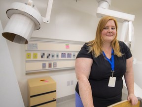 Burnaby Hospital nurse Sarah Bell stands beside a replicas emergency room boom and light made of cardboard, in a mock-up of the yet-to-be built new hospital tower.