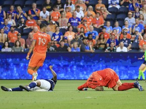Vancouver Whitecaps goalkeeper Cody Cropper (right) lands on the ground after colliding with defender Javain Brown (bottom) in the game against FC Cincinnati in the first half at TQL Stadium.