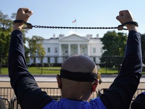 A member of the Uyghur American Association rallies in front of the White House.