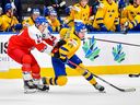 Stanislav Svozil #14 of Czechia and Jonathan Lekkerimaki #24 of Sweden keep their eyes on the game during the bronze medal game of the 2022 IIHF World Junior Championship at Rogers Place on August 20, 2022 in Edmonton, Alberta, Canada.