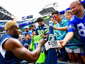 DK Metcalf of the Seattle Seahawks signs autographs for the fans prior to the preseason game against the Chicago Bears at Lumen Field on Aug.18, 2022 in Seattle, Washington.