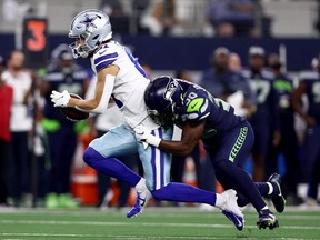 Wide receiver Simi Fehoko #81 of the Dallas Cowboys carries the ball against cornerback Mike Jackson #30 of the Seattle Seahawks in the first quarter of a NFL preseason football game at AT&T Stadium on August 26, 2022 in Arlington, Texas.
