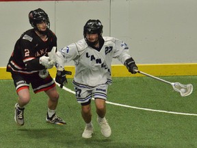 Kaden Doughty of the Langley Thunder plays keep-away with the ball against defender Will Johansen of the Nanaimo Timbermen (left) during Game 5 of the Western Lacrosse Association final on Saturday at the Langley Events Centre. Langley beat Nanaimo 11-5 to win the WLA title.