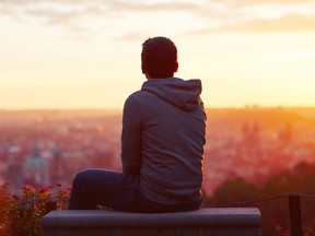 Young male traveller looking at the sunrise