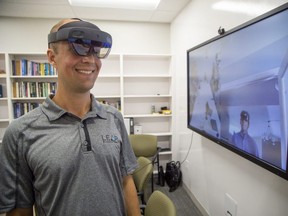 Adam Sirek, left, of Western University’s Holoportation Project meets with Nathan Ream of Aexa Aerospace in Huntsville, Ala. by 3-D holograms on Wednesday. (DEREK RUTTAN/The London Free Press)