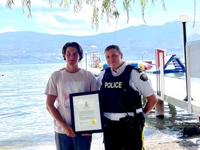 Aiden Godwin, who helped save a woman's life after a boat crash, with RCMP Supt. Kara Triance at a commendation ceremony.